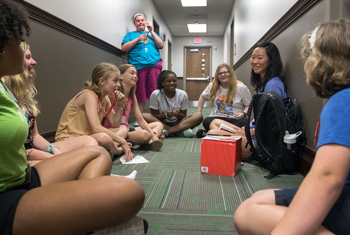 Counselor Priscilla Suh meets with her campers after their classes Tuesday, June 13. Counselors lead a meeting with their group every day after classes to recap the day and discuss the activities for the coming evening. (Photo by Brook Joyner)