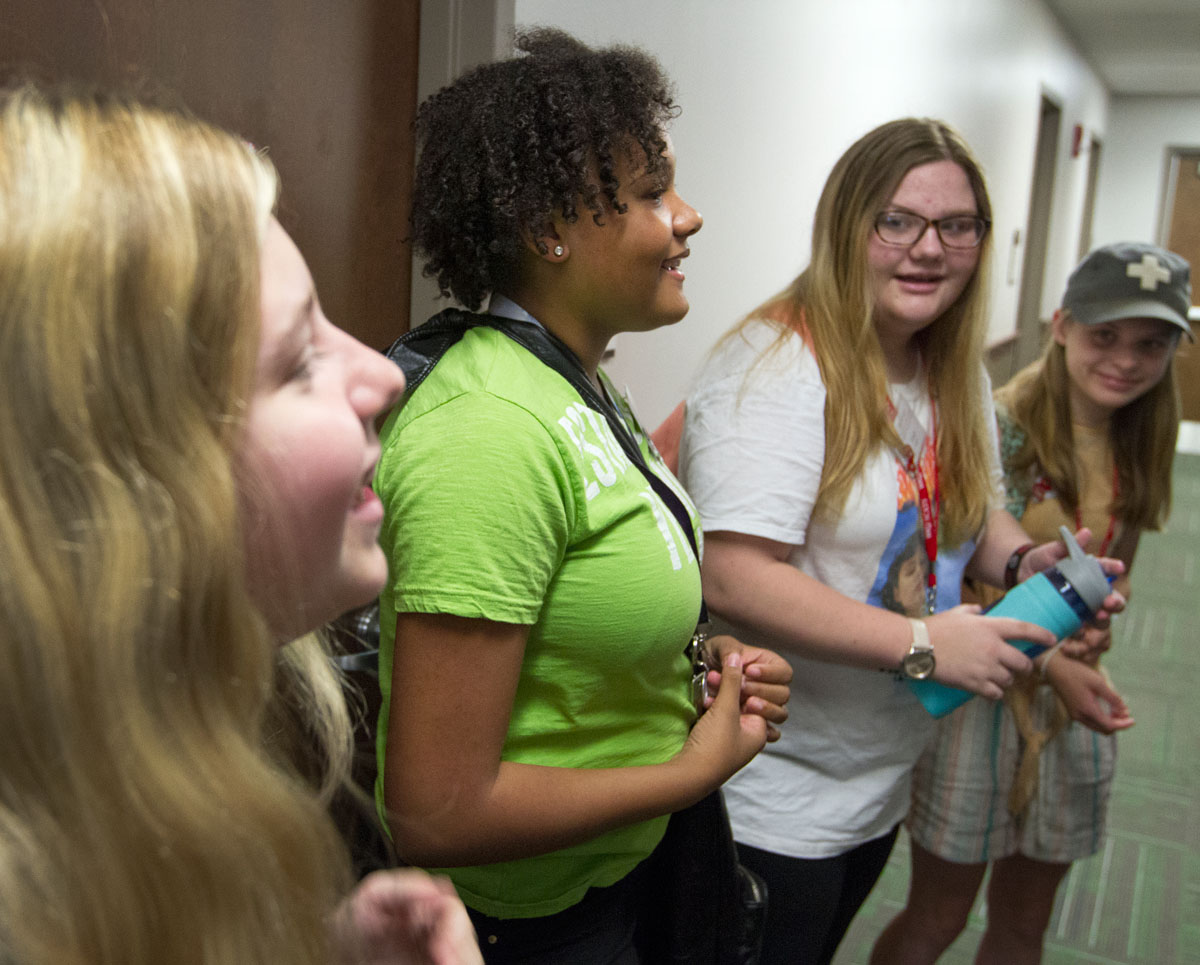 Megan Franke (from left), Serenity Johnson, Kandi Rogers, and Mary Margaret Vickers gather outside their rooms in Florence Schneider Hall before walking to breakfast with the rest of their counselor group Tuesday, June 13. (Photo by Sam Oldenburg)