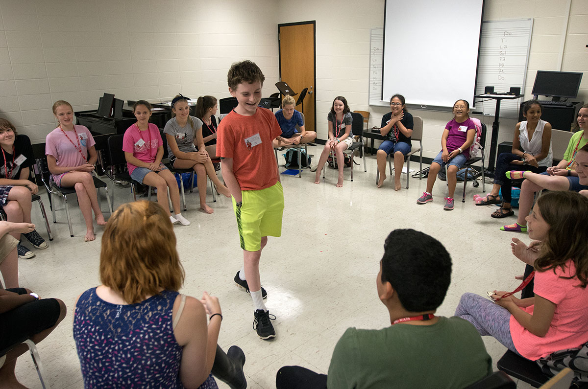 Students play a game of "Psychiatrist" at the end of Singing 101 Thursday, June 15. One student is sent out of the room and then has to figure out a pattern the rest of the class decided on by asking yes or no questions. (Photo by Brook Joyner)