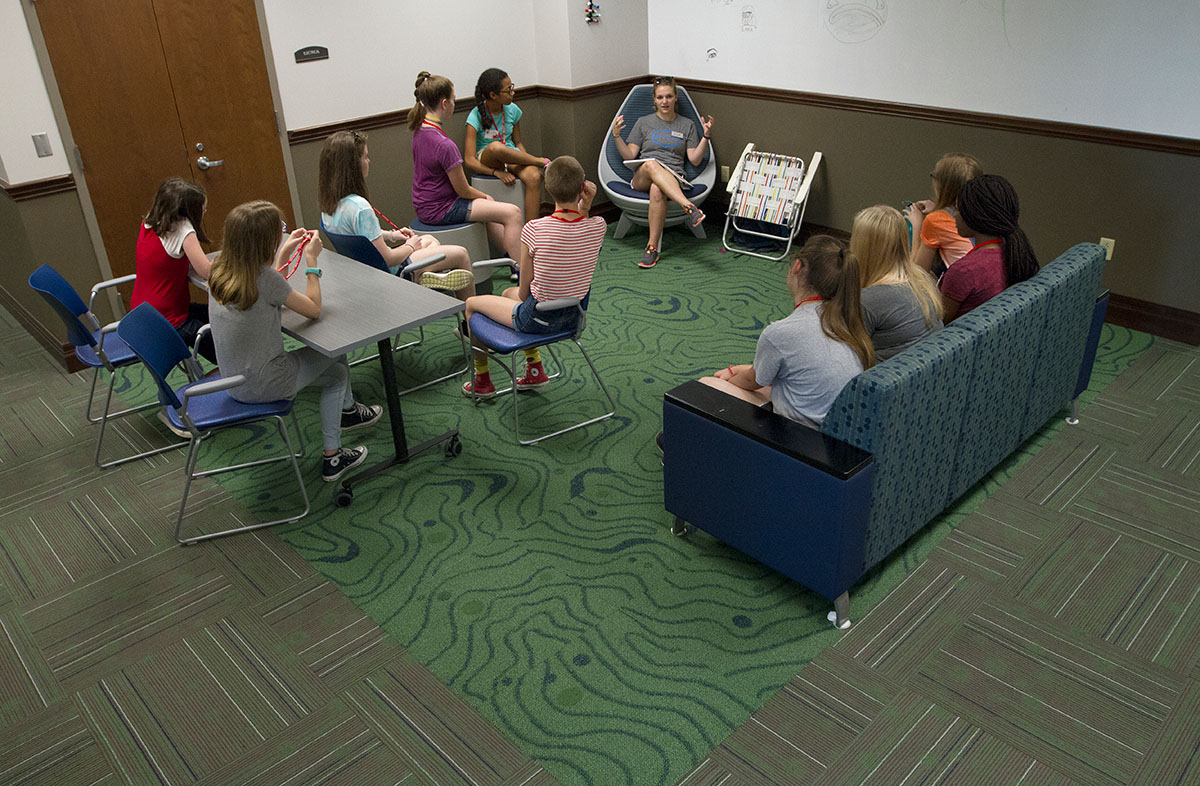 Counselor Molly Rush holds a hall meeting with her group of campers in Florence Schneider Hall after they returned from classes Monday, June 12. (Photo by Sam Oldenburg)