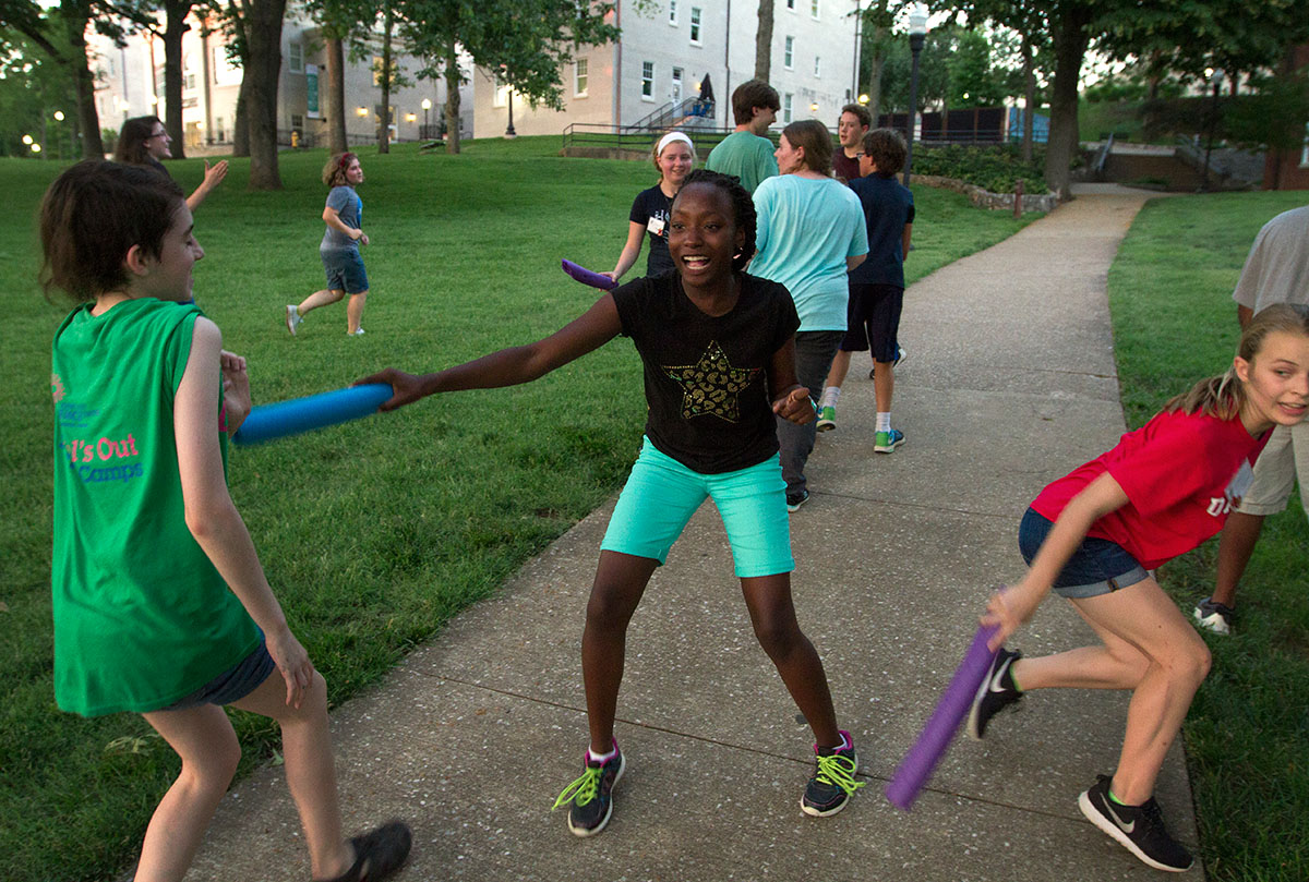 Nyomi Drayton (center) of Franklin fends off Xavier Fauver of Louisville during a game of Humans vs. Zombies during optionals Wednesday, June 14. To protect themselves, "humans" used pool noodles to tag "zombies" who would then have to return to their base to respawn. (Photo by Sam Oldenburg)