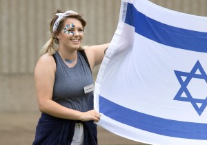 Counselor Maddie Hamblin carries the Israeli flag during the opening ceremonies of the SCATS Olympics Saturday, June 17. Maddie's group, which chose to represent Israel, went on to win first place in the competition. (Photo by Brook Joyner)