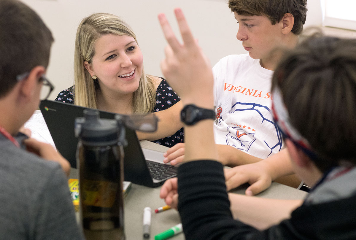 Stephanie Gahafer talks to students about their group project in Government and Economics Monday, June 19. Groups each got to create an original country and make decisions about the country's government, laws, and industries. (Photo by Brook Joyner)
