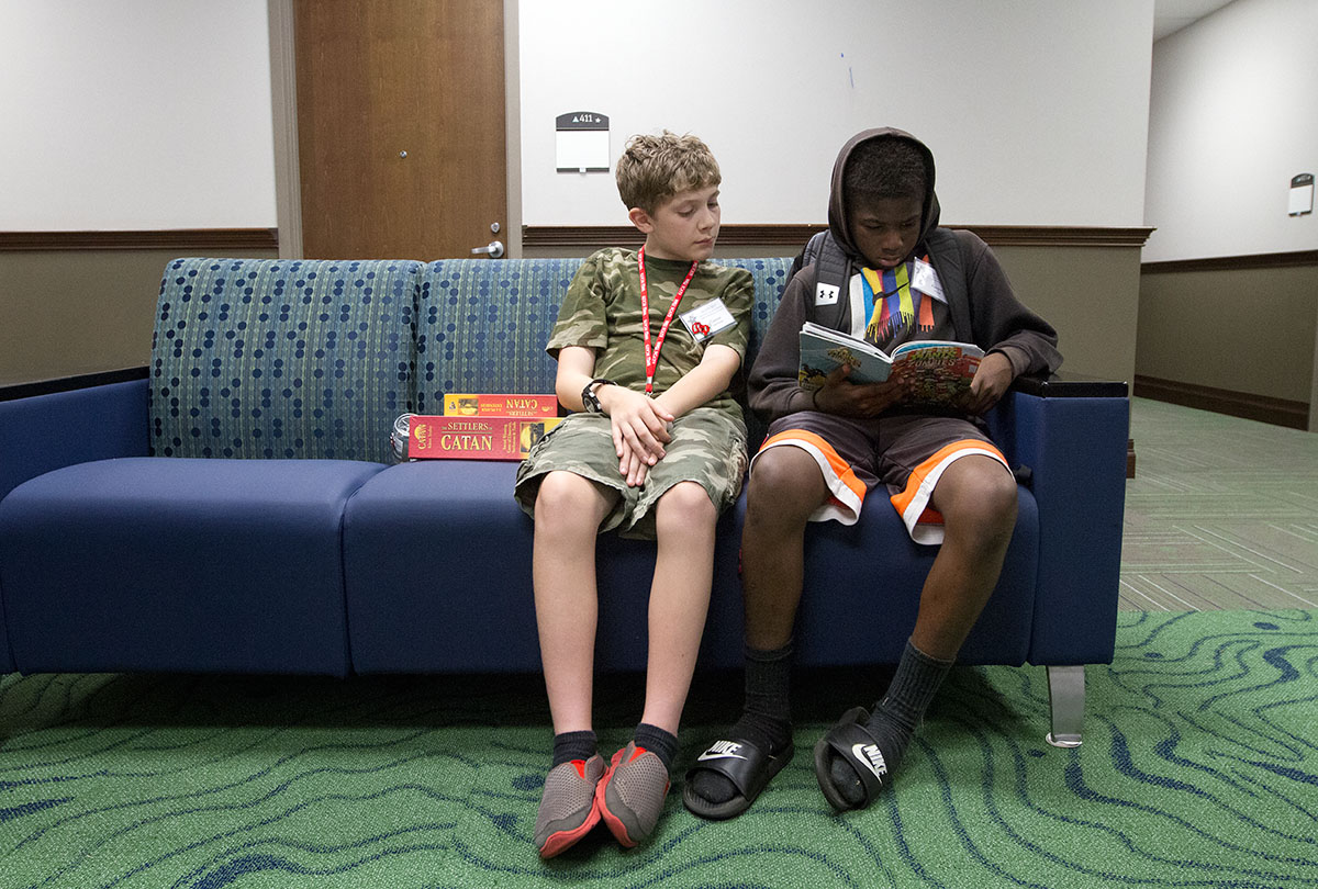 Connor Normand (left) from Bowling Green and Kenyan Wood from Horse Cave look at a book together during hall time Monday, June 12. (Photo by Sam Oldenburg)
