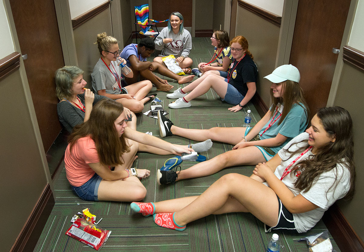 Tori Edwardson's campers laugh with each other while learning to play the game Werewolf during hall time Monday, June 19. (Photo by Sam Oldenburg)