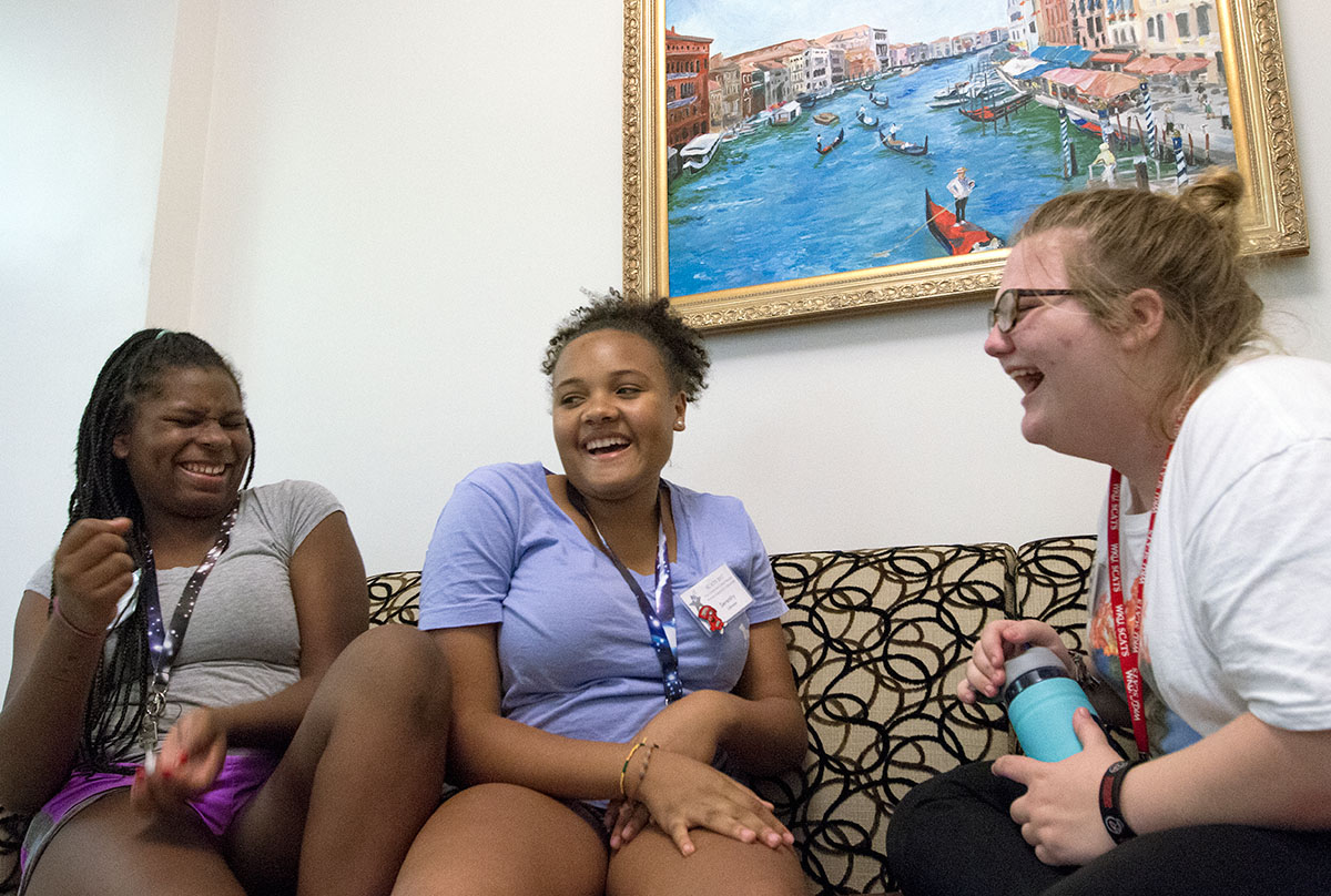 Jasmine Miles (from left) of Union, Serenity Johnson of Louisville and Kandi Rogers of Owensboro share a laugh during community time Monday, June 19. (Photo by Sam Oldenburg)