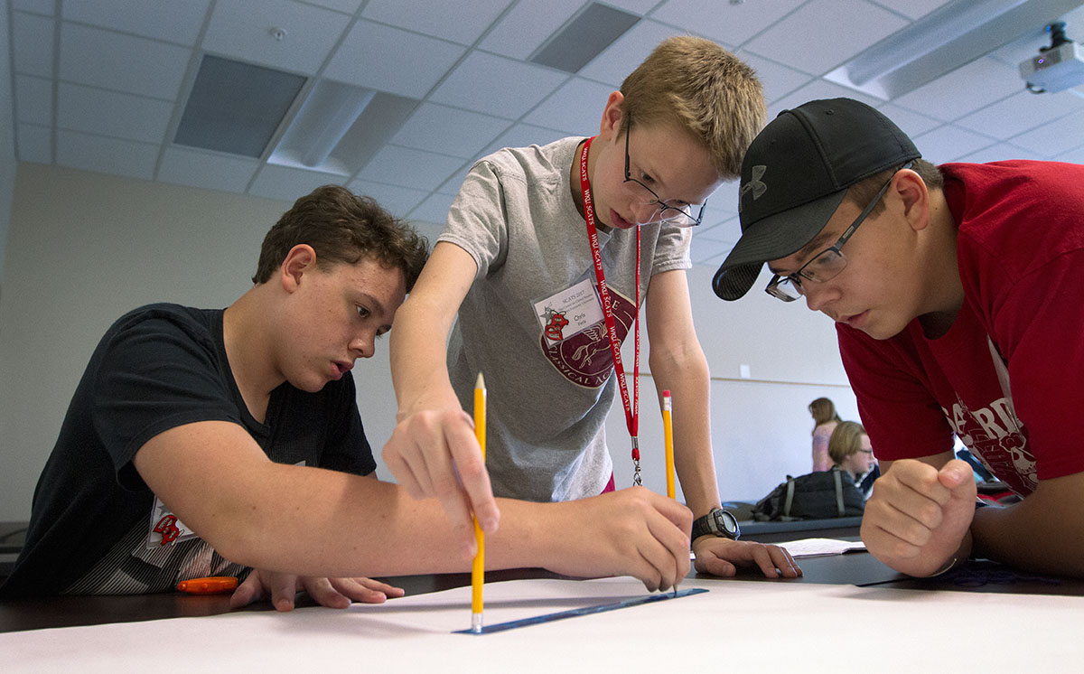 Cole LaDow (from left) of La Grange, Chris Paris of Prospect and Trace Gearlds of Tompkinsville work on a project in From Mars to Mutations Tuesday, June 20. The group was drawing a circle for an Ozobot to navigate in order to simulate a space mission. (Photo by Sam Oldenburg)