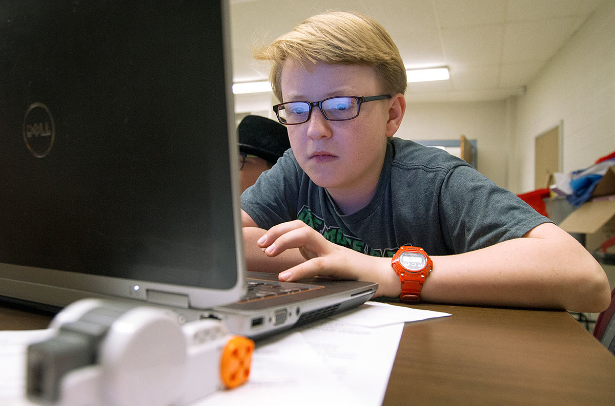 W.P. Hurt of Edmonton writes a program for a Lego robot during STEAM Labs Wednesday, June 28. (Photo by Sam Oldenburg)