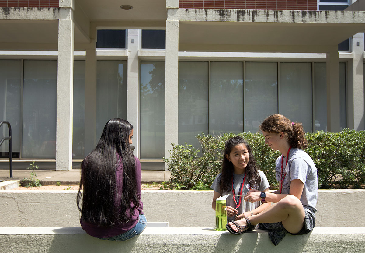Amirta Manikandan (from left) of Cordova, Tenn., Susan Lin of Louisa, and Kiersten Hamilton of Georgetown hang out during their class break outside Thompson Complex Central Wing Monday, June 26. (Photo by Brook Joyner)