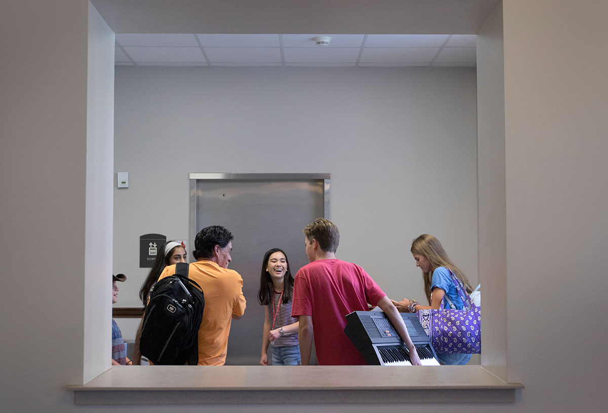 Campers move their belongings into Florence Schneider Hall on the first day of VAMPY Sunday, June 25. (Photo by Brook Joyner)