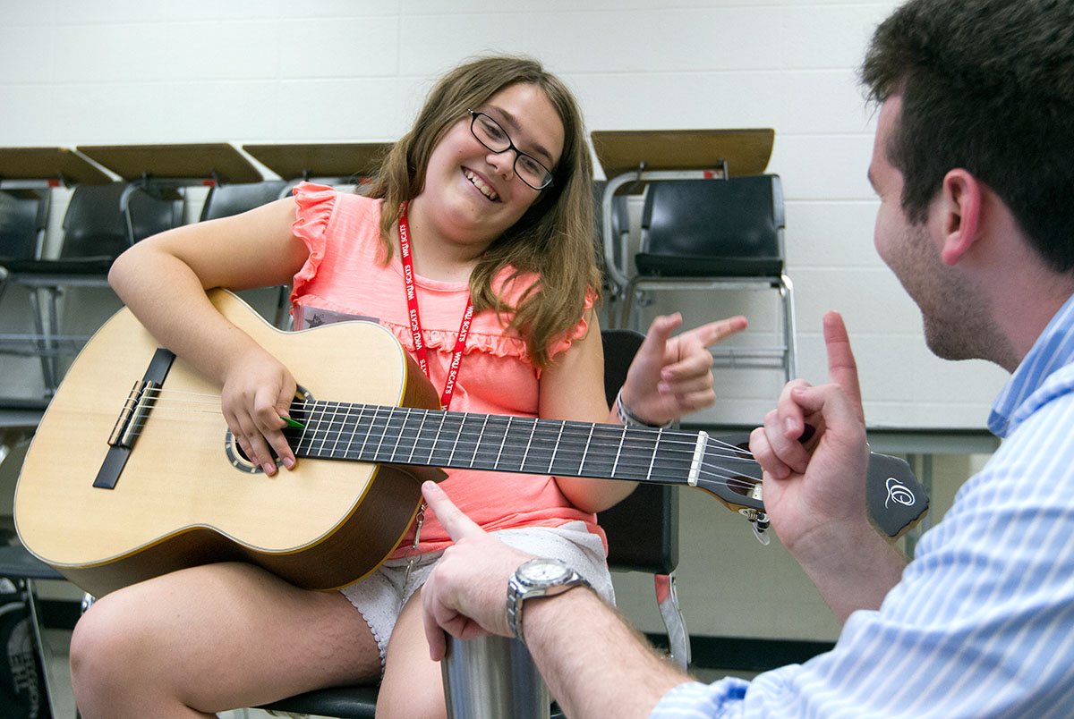 Alli Wagner from Leitchfield talks with Guitar 101 teacher Charles McManus while rehearsing a song she converted to tabs Thursday, June 22. (Photo by Sam Oldenburg)