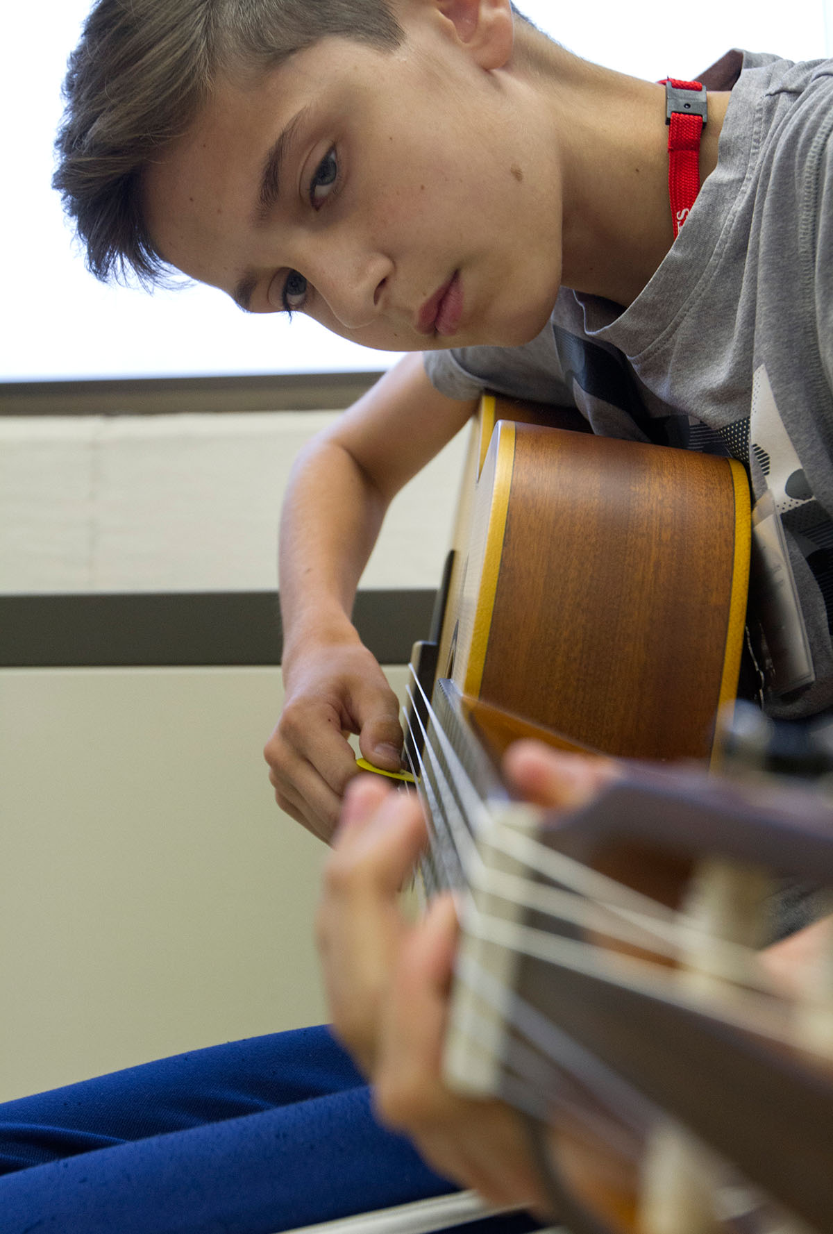 Seth Pendleton of Louisville checks his fingering while rehearsing a song he converted to tabs in Guitar 101 Thursday, June 22. (Photo by Sam Oldenburg)