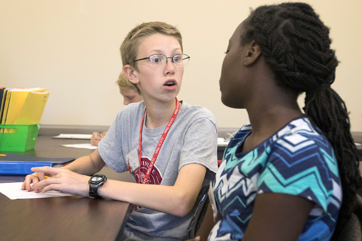 Chris Paris (left) of Prospect and Nyomi Drayton of Franklin discuss the design for their popsicle stick structure in Shake, Rattle, and Roll Tuesday, June 20. The project taught students about what types of structures hold up best in areas where earthquakes occur. (Photo by Brook Joyner)