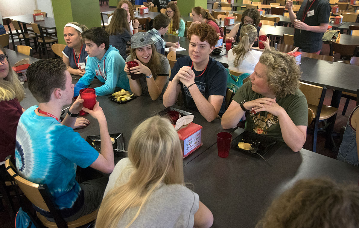 Tommy Pack (center) of Frankfort and MacGregor Lakes (right) of Berea visit with other campers at breakfast Monday, June 26. Campers ate breakfast, lunch, and dinner together in Fresh Food Company. (Photo by Brook Joyner)