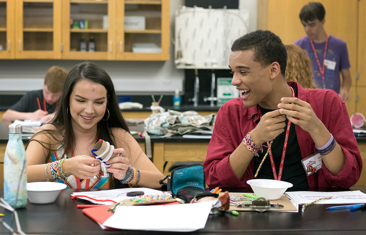 Melina Durham (left) of London, Ky., and Malcolm Jones of Louisville use pipe cleaners and beads to build models of DNA structures in DNA and Genetics Monday, June 26. (Photo by Brook Joyner)