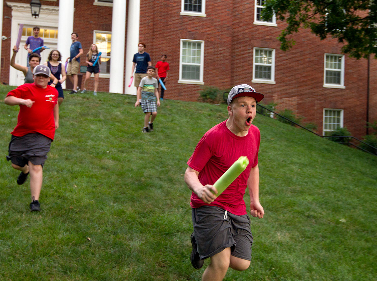 Griffin Salsman of Springfield, Tenn., charges down the lawn in front of McLean Hall while playing Humans vs. Zombies during optional time Monday, June 26. (Photo by Sam Oldenburg)