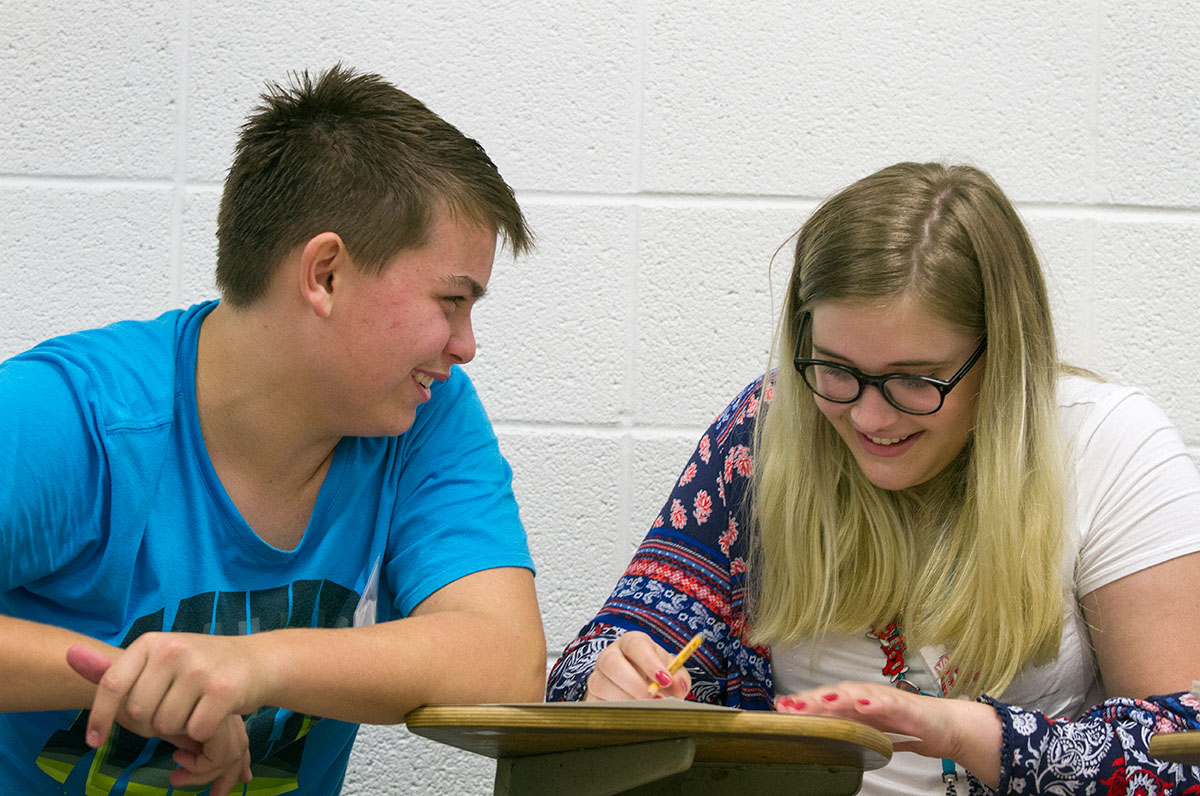 Dawson Wilcox of Greenville, Ala., offers input to Emma Lauritzen of Lexington whil she sketches their campaign poster promoting the re-election of John F. Kennedy during study hall for their class, Presidential Politics, Monday, June 26. (Photo by Sam Oldenburg)