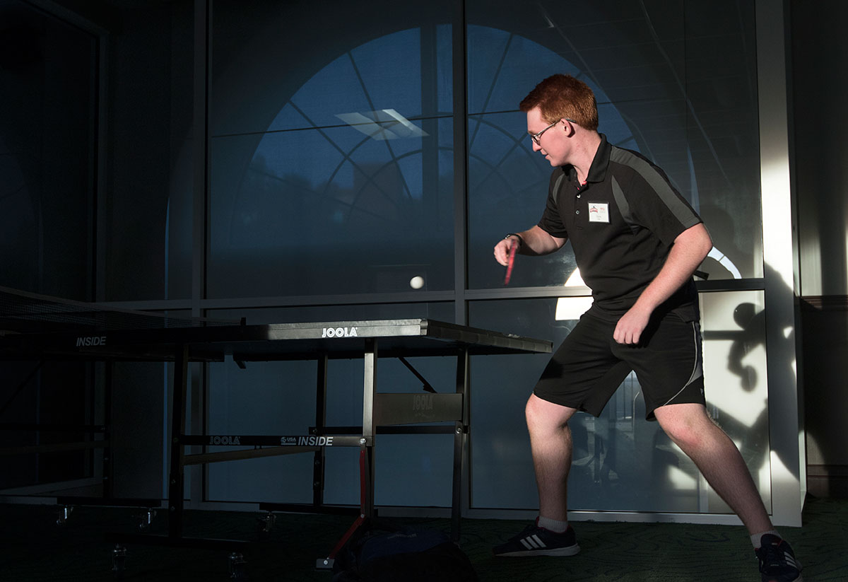 Cayce Jones of Versailles competes in a game of ping pong Wednesday, June 29. Other campers played air hockey, foosball, and card games in the den on the top floor of Florence Schneider Hall. (Photo by Brook Joyner)