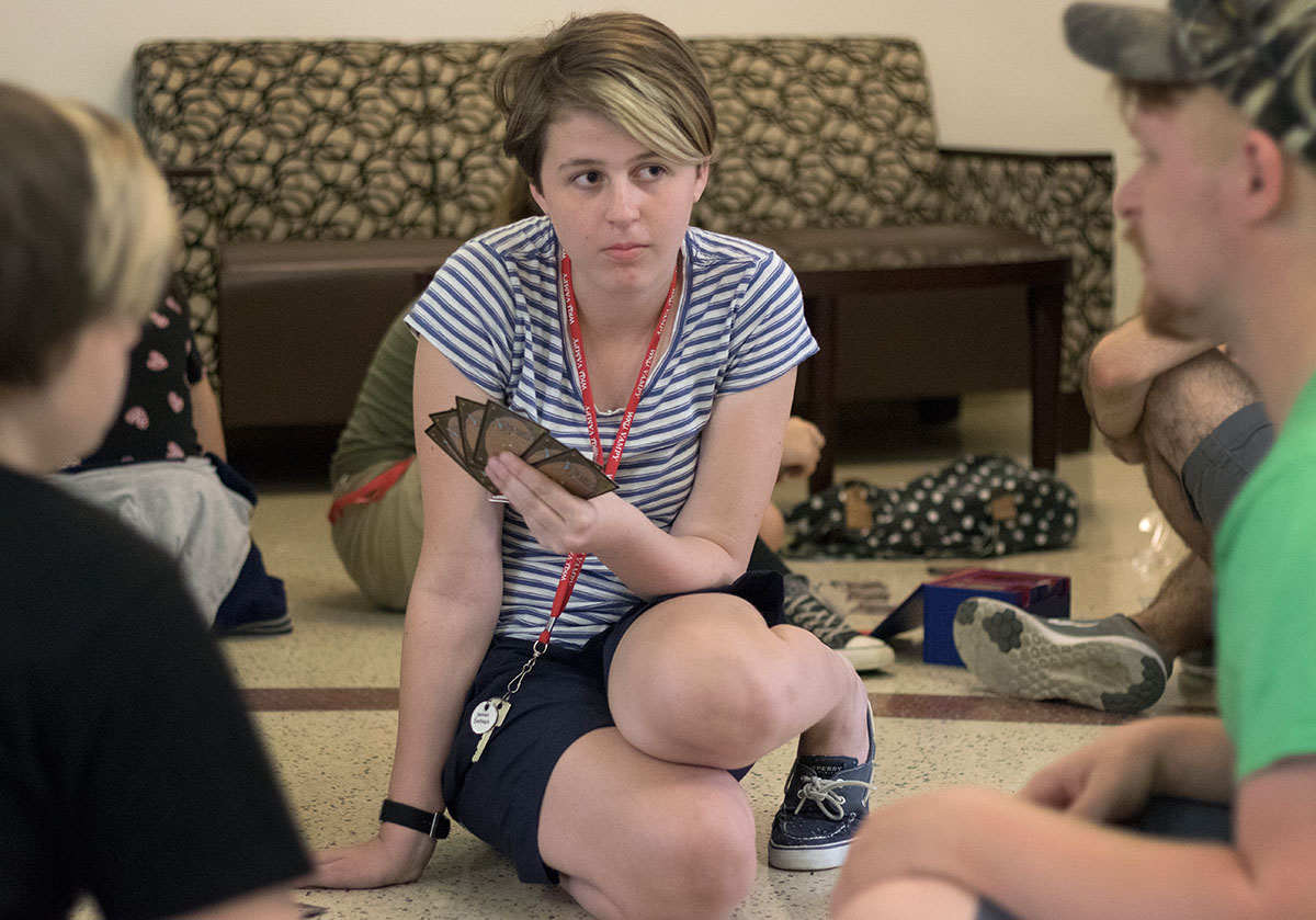 Hannah Bachrach of Brentwood, Tenn., listens to counselor Aaron Bard explain rules for Magic: The Gathering during the Magic for Beginners optional Wednesday, June 28. (Photo by Brook Joyner)