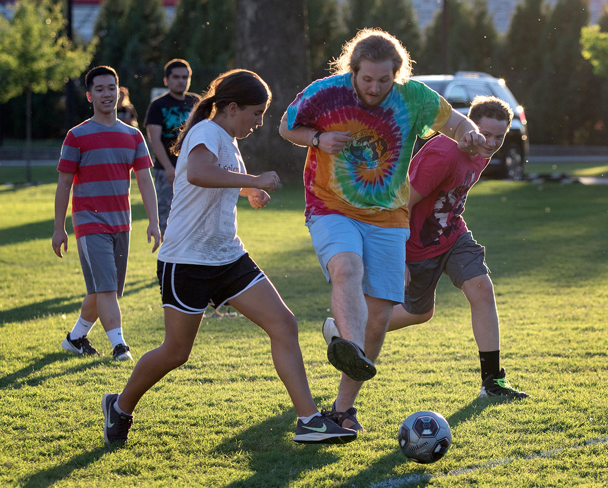 Claire Pinkston of Versailles and counselor Sam Kernohan fight for the bal during a soccer optional Tuesday, June 27. (Photo by Brook Joyner)