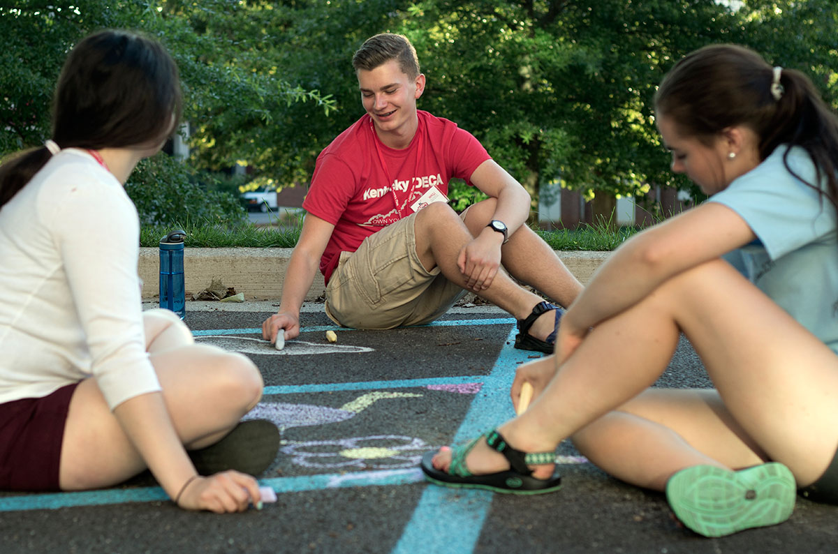 Jacob Conway of Georgetown hangs out with other campers at the chalk drawing optional Tuesday, June 27. Optionals allow give the campers a break after spending the day in class. (Photo by Brook Joyner)