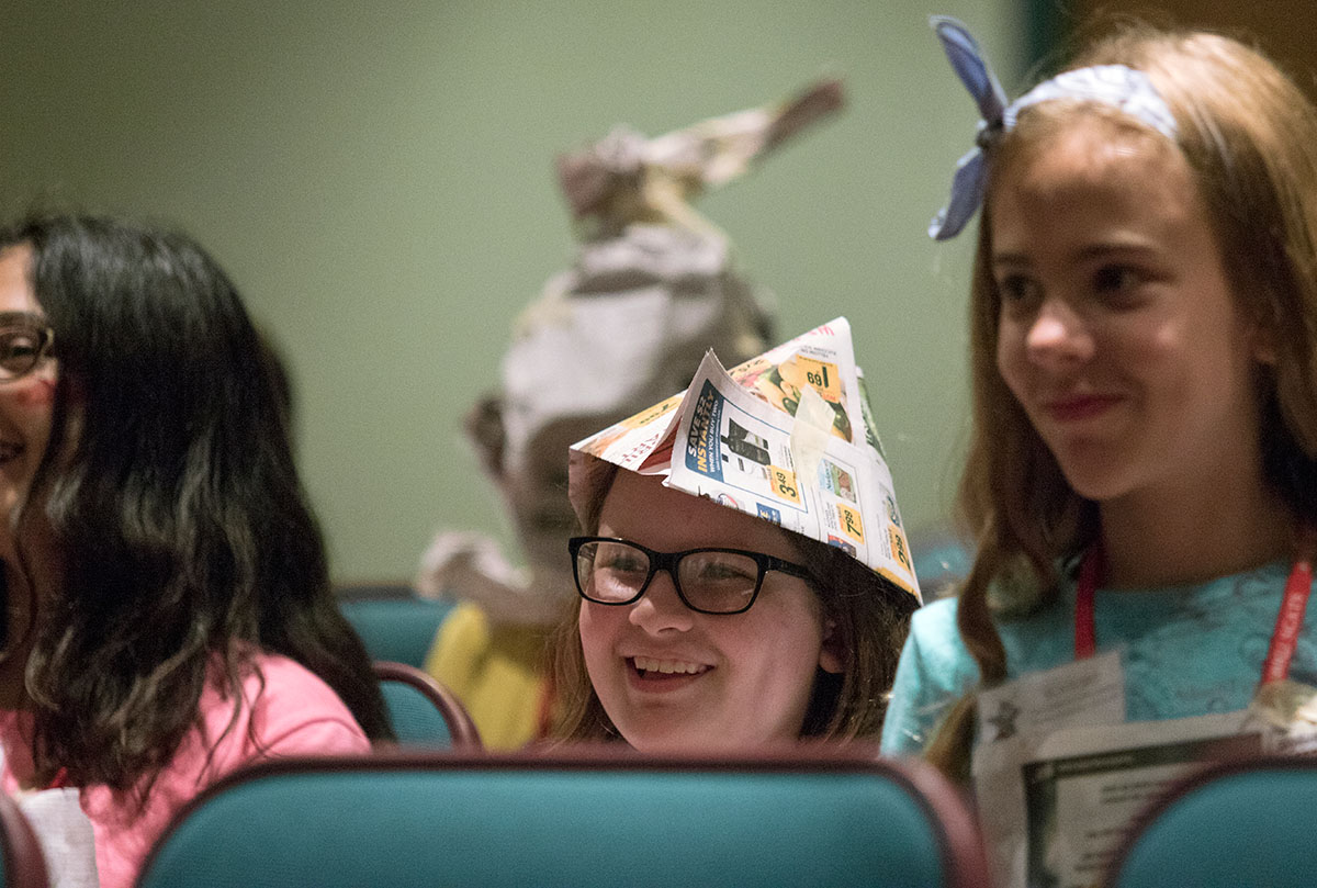 Lily Simpson of Bowling Green watches another group perform during paper theater Saturday, June 17. Lily's group was the last to take the stage and they performed a version of "Beauty and the Beast." (Photo by Brook Joyner)