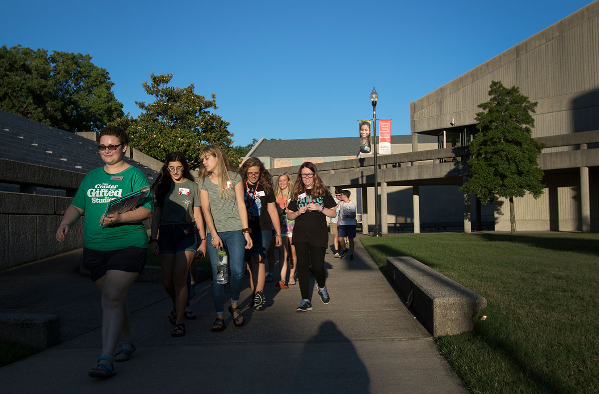 Counselor Lillie Shaw leads her campers on a campus tour Sunday, June 25. Campers learned where their classes would be held, as well as the designated walking route. (Photo by Brook Joyner)