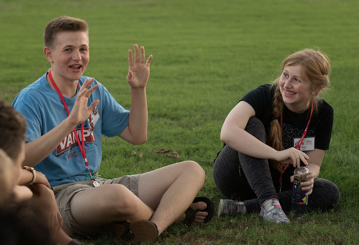 Stuart Kernohan and Darby Tassell, both of Bowling Green, play an icebreaker game Sunday, June 25. Each camper told a fact about themselves and the rest of the group had to guess wether it was a truth or a lie. (Photo by Brook Joyner)