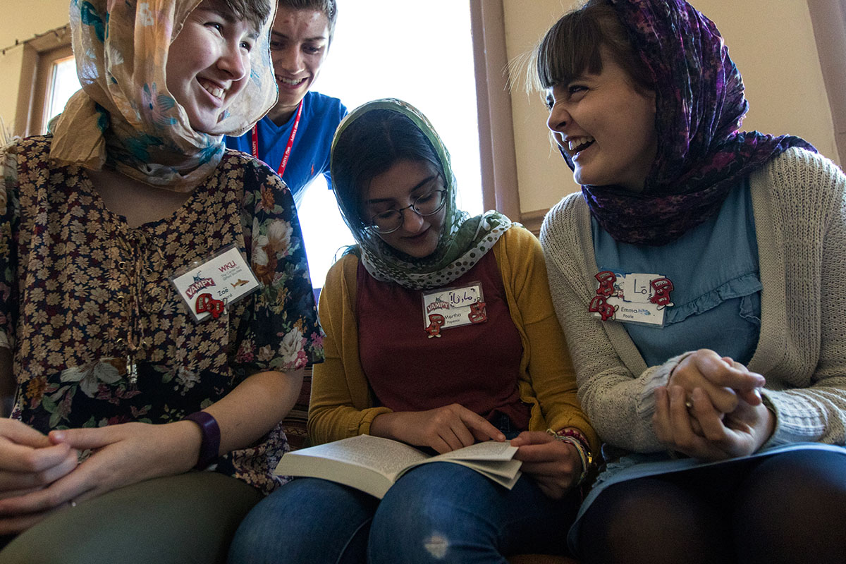 Zoe Ward (from left), Elias Smith, Martha Popescu, and Emma Poole look at a Quran while visiting the Muslim American Cultural Center in Nashville Tuesday, July 11. (Photo by Brook Joyner)
