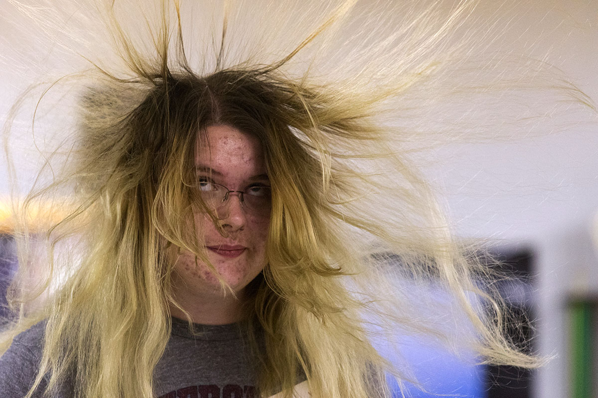Caitlyn Epley of Russellville watches her hair raise after placing her hand on a Van de Graaf generator in Physics Wednesday, July 12. The Physics class headed to Warren Central High School, where teacher Kenny Lee works, to watch and participate in a series of demonstrations about waves. (Photo by Brook Joyner)