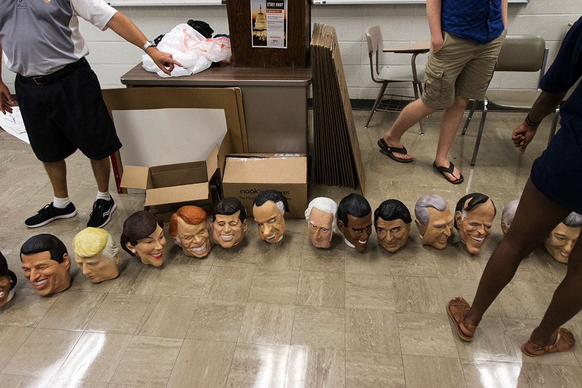 Presidential Politics teacher Dennis Jenkins lines up masks of former and present presidents and first ladies in class Friday, July 14. (Photo by Brook Joyner)