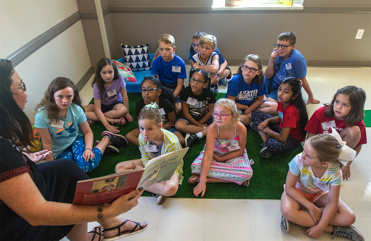 Math teacher Allison Bemiss reads a book to her class Monday, July 10. Students completed a series of activities that went along with the story in order to learn about probability and chance. (Photo by Brook Joyner)