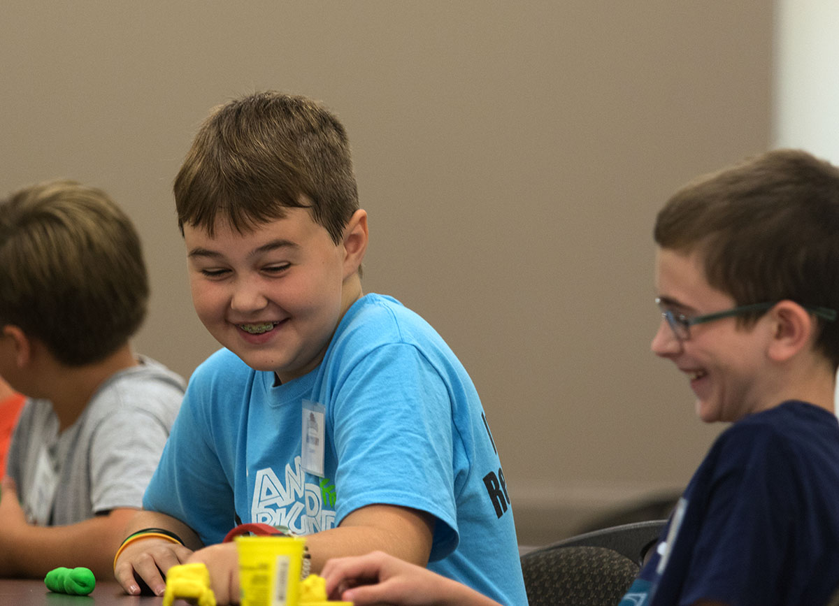Anthony Counts (left) laughs with a fellow camper during an ice breaker activity in Science Monday, July 10. (Photo by Brook Joyner)
