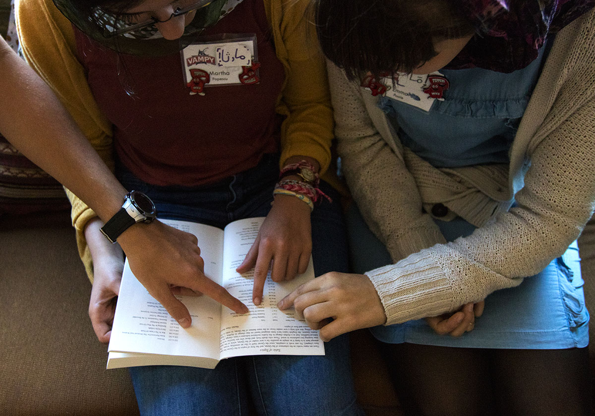 Elias Smith (from left) of Somerset, Martha Popescu of Hanson, and Emma Poole of Central City read a copy of the Quran at the Muslim American Cultural Center in Nashville Tuesday, July 11. Arabic students also listened to a presentation about Islam from one of the mosque leaders. (Photo by Brook Joyner)