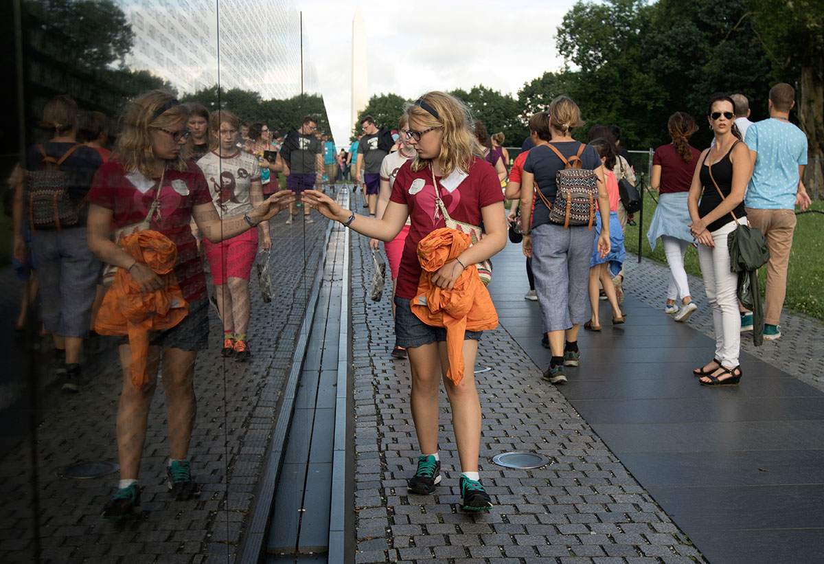 Abby Adams-Smith of Bowling Green runs her hand along the Vietnam Veterans Memorial Wall in Washington D.C. Thursday, July 6. Students also visited memorials for World War II and the Korean War. (Photo by Brook Joyner)