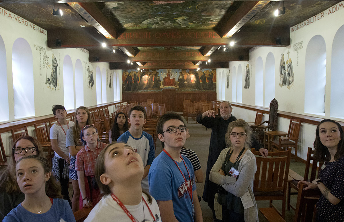 Humanities students view the artwork in the Chapter Room at Saint Meinrad Archabbey Monday, July 3. The murals were painted by a monk in the 1940s whose art was also featured in other areas of the monastery. (Photo by Brook Joyner)
