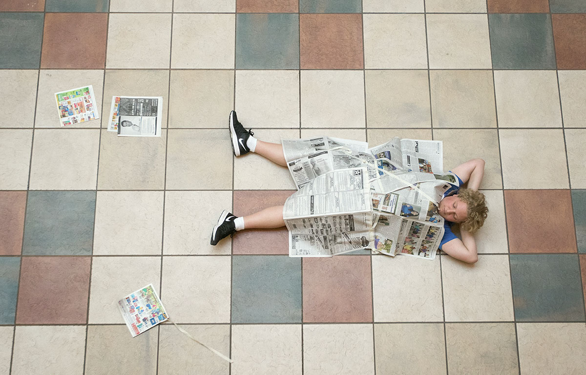 MacGregor Lakes of Berea lays on the floor of Mass Media and Technology Hall after completing his costume for paper theater Saturday, July 1. (Photo by Brook Joyner)