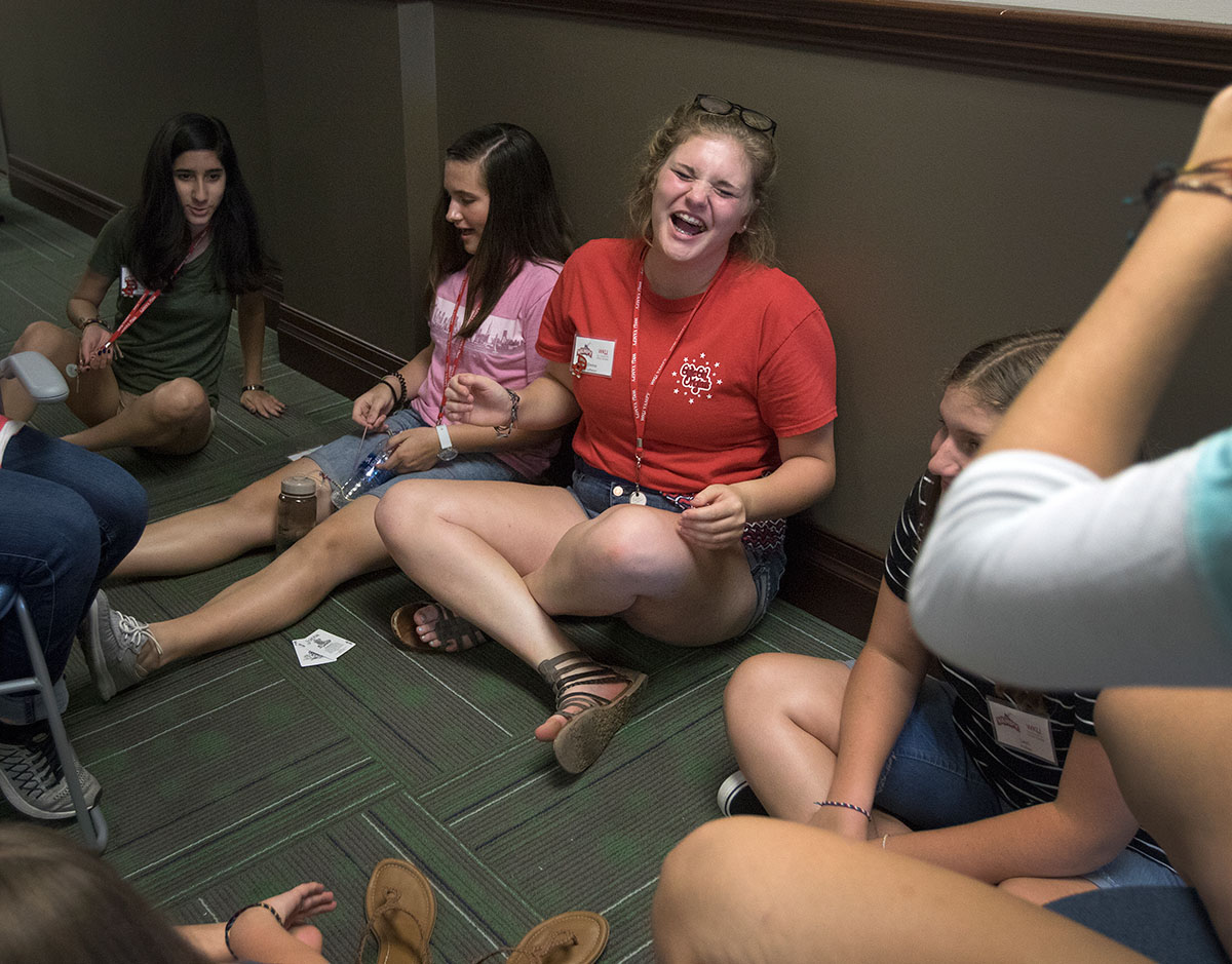 Emma Latherow of Ashland visits with her hall mates before heading to dinner Sunday, July 2. Emma then went on to sing and play ukulele for the girls on her hall. (Photo by Brook Joyner)