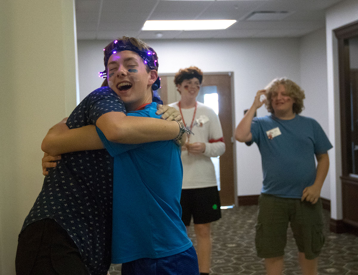 James Crider of Marion hugs Mary Baker of Paducah after she helped team Israel win a round of musical chairs Saturday, July 1. Israel placed first overall for the annual VAMPY Olympics. (Photo by Brook Joyner)