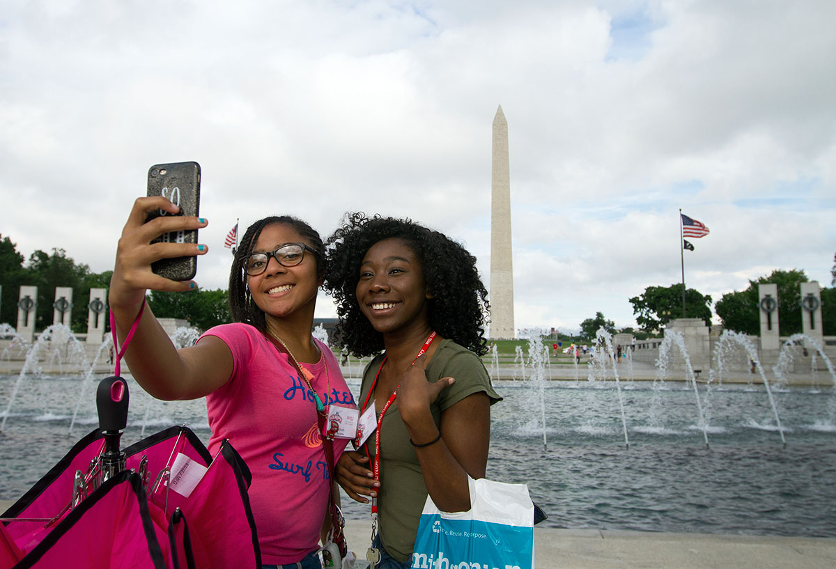 Mikah Burdette (left) of Lexington and Tasia Cole of Louisville take a selfie in front of the World War II Memorial and the Washington Monument during a field trip to Washington D.C. Thursday, July 6. (Photo by Sam Oldenburg)