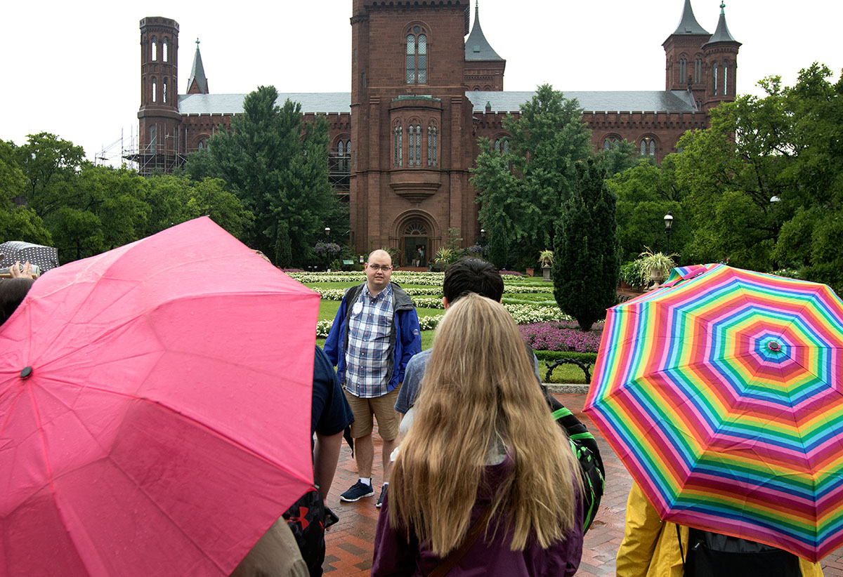 Justin Mitchell tells his Pop Culture students about the history of the Smithsonian Institution Building in Washington D.C. Thursday, July 6. (Photo by Brook Joyner)