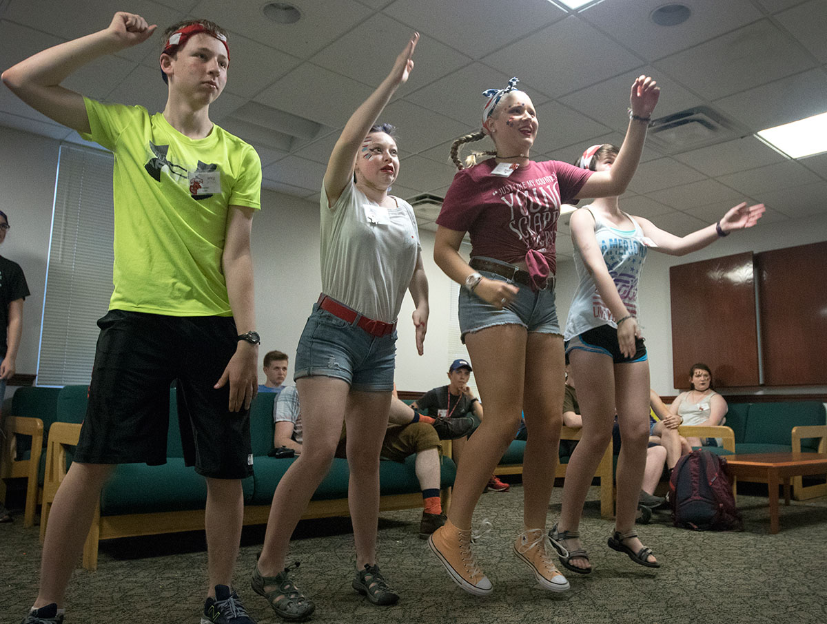 Hayden Lovel (from left), Evvie Cooley, Maggie Kite, and Zoe Ward compete in a round of Just Dance in McLean Hall Saturday, July 1. Each camper had to follow the dance moves showed on screen and the person who scored the highest won points for their team. (Photo by Brook Joyner)